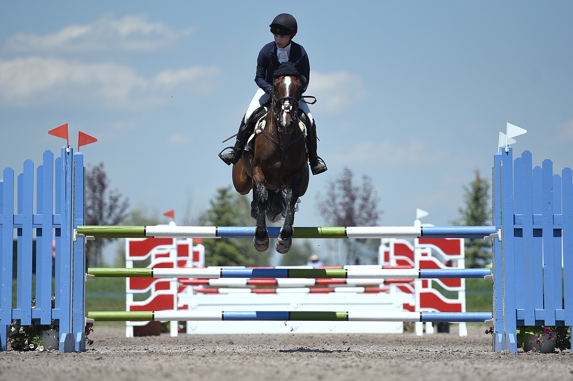 Amber Levine on horse Cinzano clears a jump during Open Intermediate Show Jumping at The Event at Rebecca Farm on Saturday. (Casey Kreider/Daily Inter Lake)