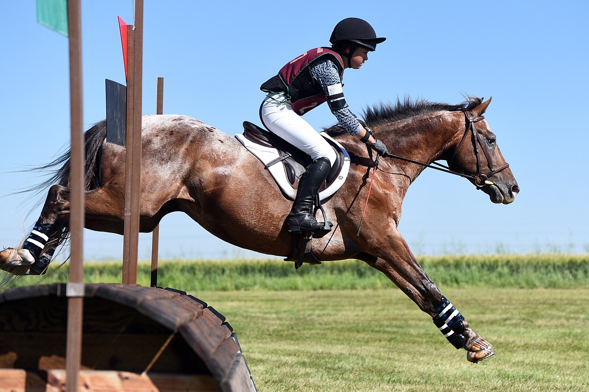 Alexandra Nigg rides her horse Kuna Awassis over a jump on the cross-country course during The Event at Rebecca Farm on Friday. (Casey Kreider/Daily Inter Lake)