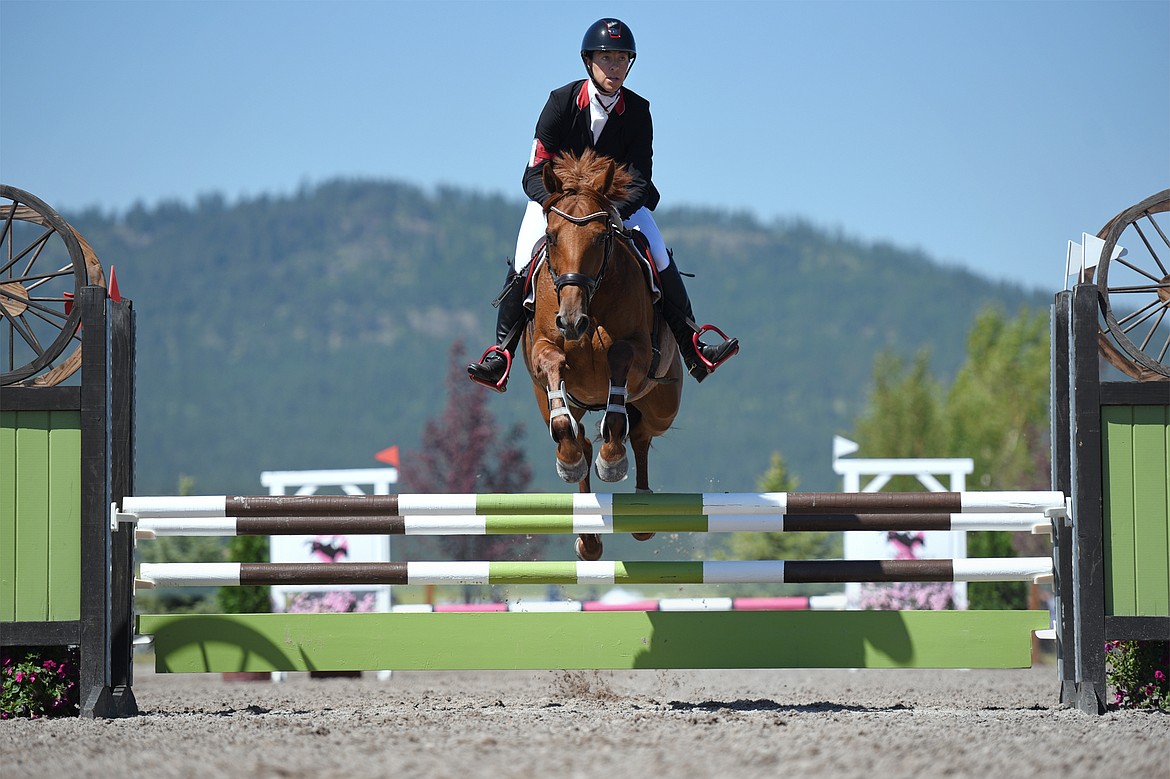 Jenny Holbrook rides her horse Wiski HTF over a jump in Show Jumping Ring 3 in the Senior Open Novice C category during The Event at Rebecca Farm on Friday. (Casey Kreider/Daily Inter Lake)