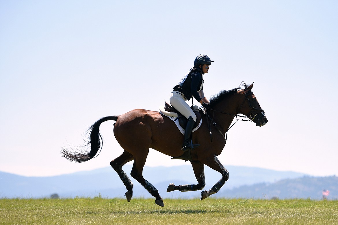 Grace Smith on horse Sir Saulsford Nazar rides along an open stretch of the cross-country course during The Event at Rebecca Farm on Saturday. (Casey Kreider/Daily Inter Lake)