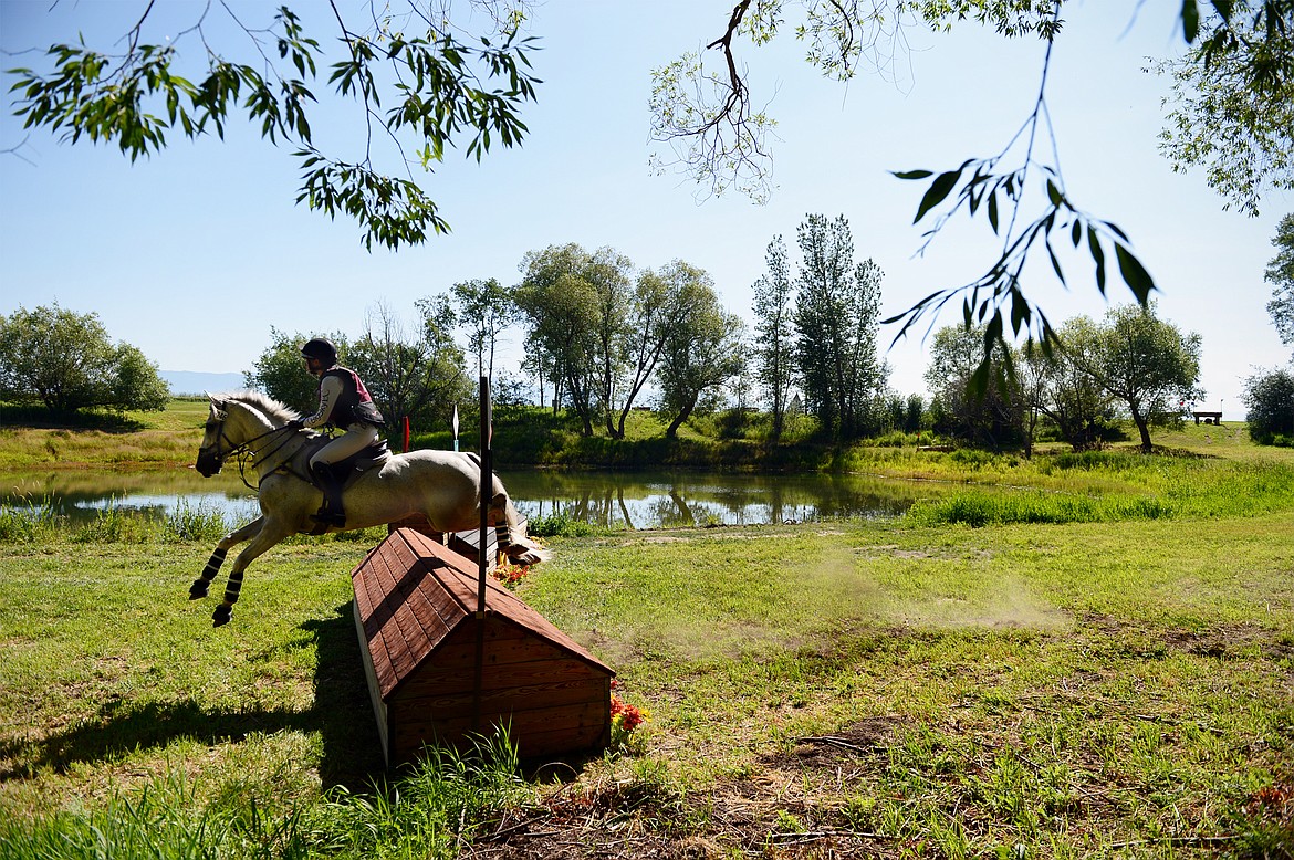 Haley Abbett rides her horse Limitless over a jump on the cross-country course during The Event at Rebecca Farm on Friday. (Casey Kreider/Daily Inter Lake)