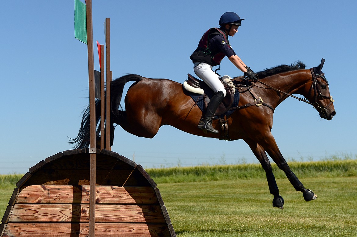 Ali Holmes-Smith rides her horse CC Quiet Riot over a jump on the cross-country course during The Event at Rebecca Farm on Friday. (Casey Kreider/Daily Inter Lake)