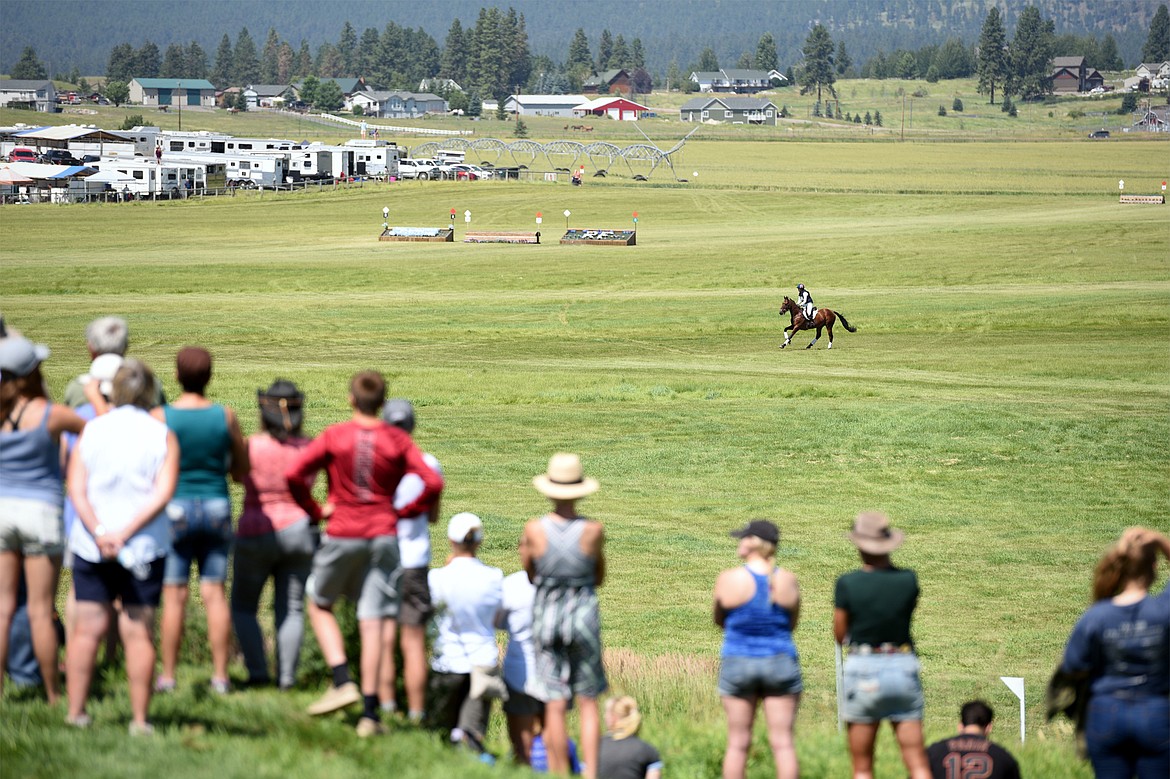 Attendees on Spectator Hill watch a horse and rider gallop along an open stretch of the cross-country course during The Event at Rebecca Farm on Saturday. (Casey Kreider/Daily Inter Lake)