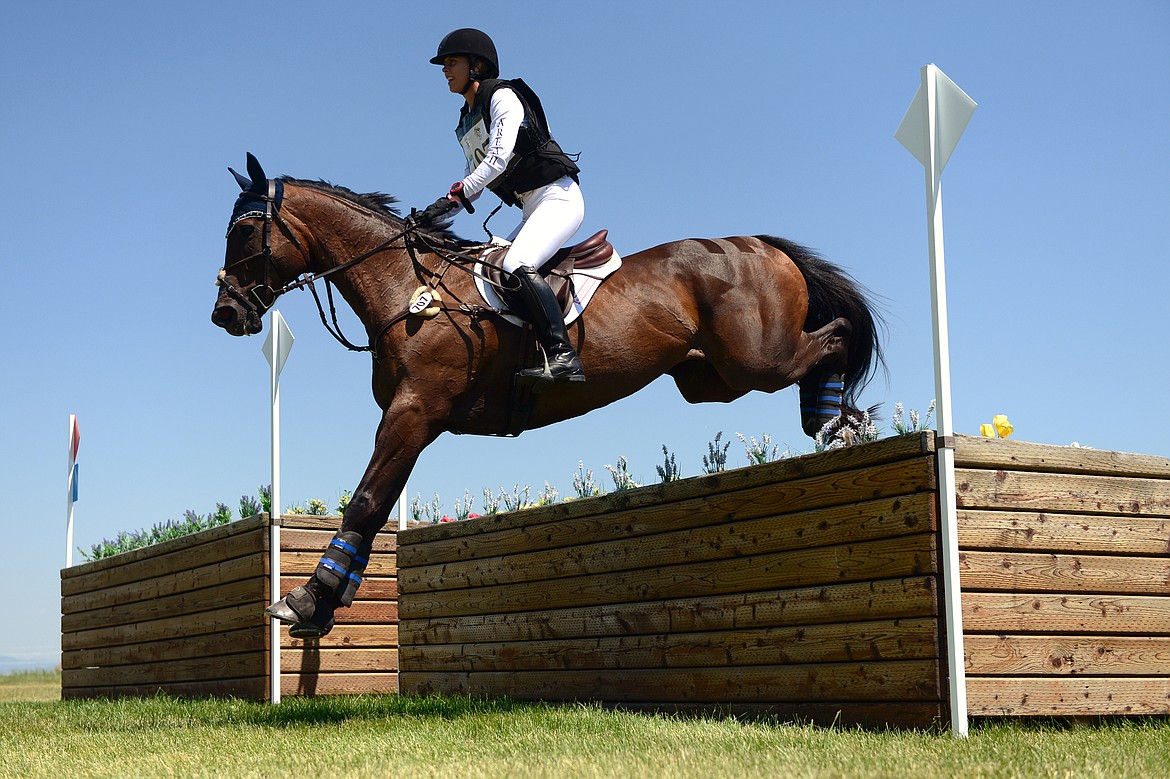 Macy Beach on horse Chasing Moonlight clears a jump on the cross-country course during The Event at Rebecca Farm on Saturday. (Casey Kreider/Daily Inter Lake)