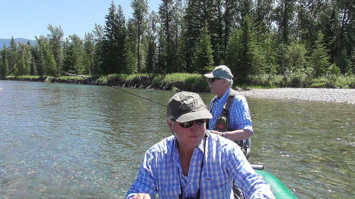 Trout Unimited Flathead Valley chapter president Larry Timchak, front, pilots a raft while Jim Borowski tries to tempt a trout into striking during Friday's Veterans Float on the Flathead River near Kalispell. Borowski, who served in the U.S. Marines during Vietnam war, coordinates the veteran's service partnership program for the chapter. (Scott Shindledecker/Daily Inter Lake)