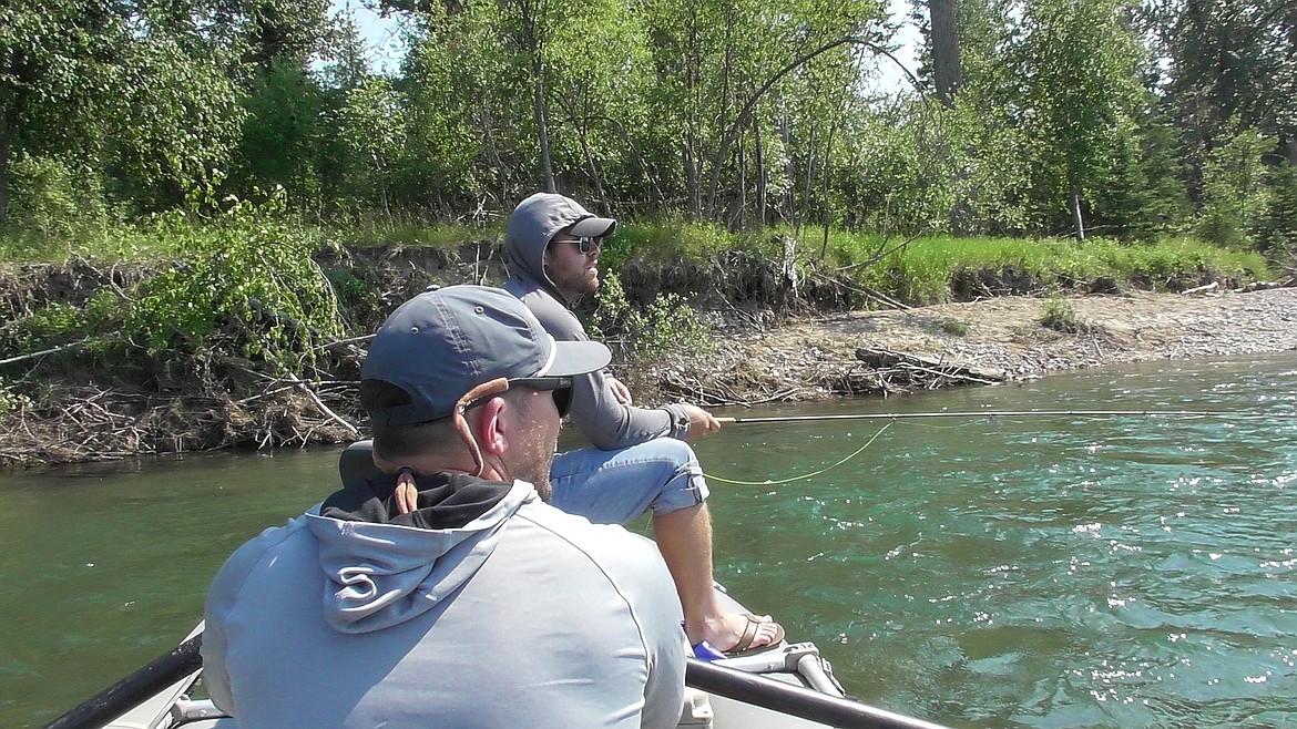 Peter Ziehli works to get a trout to his dry fly while Kalispell's Kyle Smalley mans the oars of their raft and offers his expertise during the Trout Unimited Flathead Valley chapter's Veterans Float on the Flathead River. Ziehli, who served in the U.S. Army during the Afghanistan war, has realized the benefits of fishing as he copes with Post Traumatic Stress Disorder. (Scott Shindledecker/Daily Inter Lake)