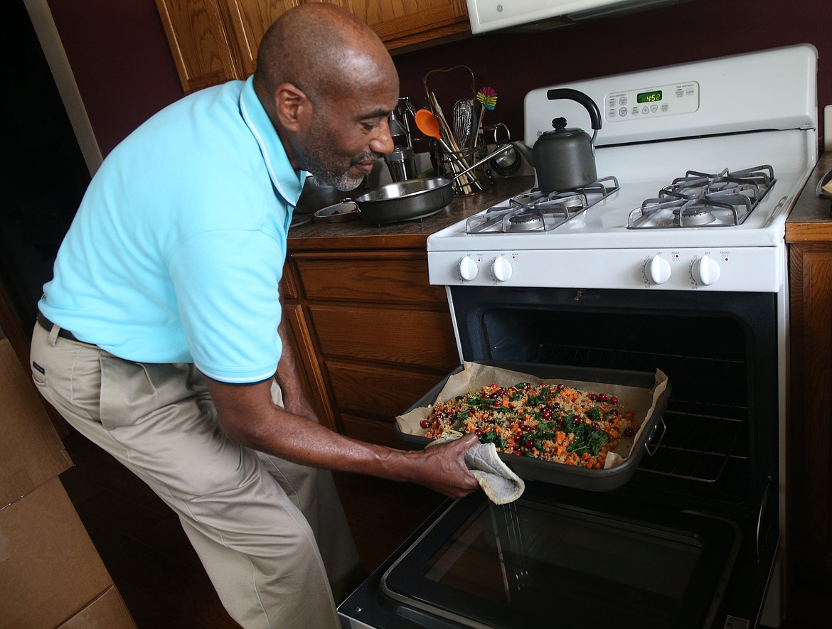LOREN BENOIT/Press
Al Milligan has a wide background of experience as an attorney, a policeman, a health coach and a chef. Here, Al prepares a quinoa dish made with spinach, cranberries and sweet potatoes for family dinner.