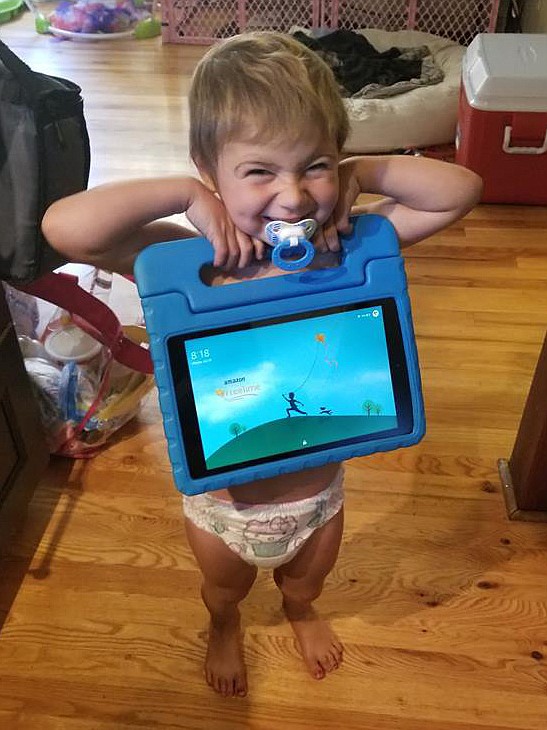 Sophia Moss, age 3, shows her excitement at having her Kindle access restored by Amazon. Moss, who is battling cancer, watches the Kindle during chemotherapy sessions. (photo provided)