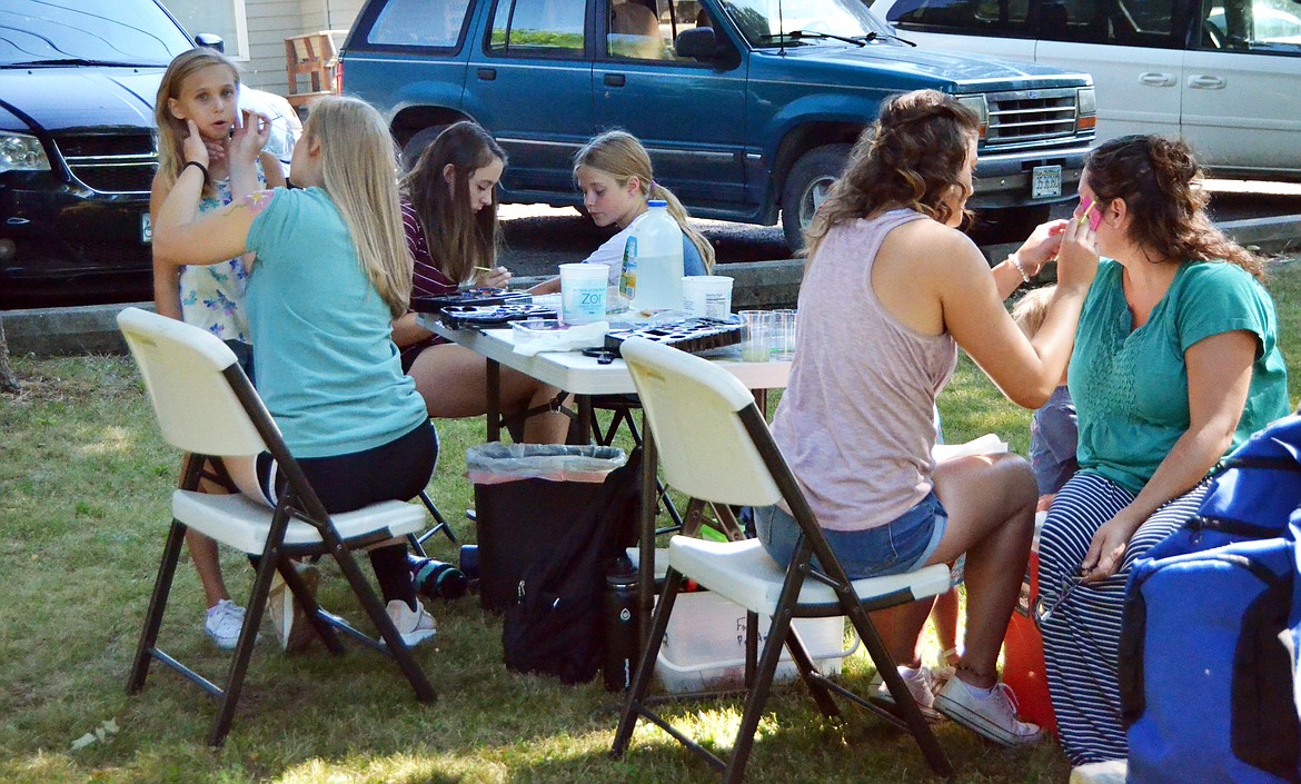 Reflections All-Girls School students were busy from the get go at their face painting table during the Chicken Jamboree. (Erin Jusseaume/ Clark Fork Valley Press)