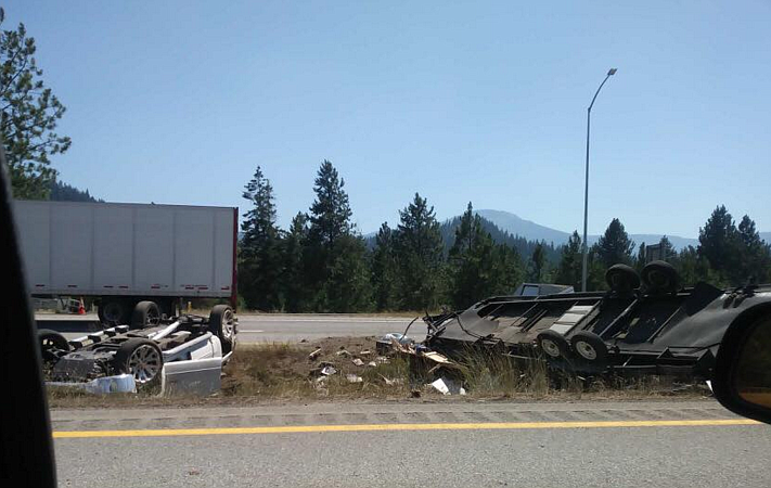 The truck and trailer tipped over in the median after the accident occurred in the westbound lane.