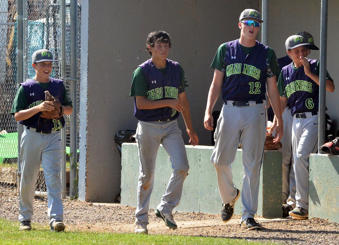 THE MISSION Valley Mariners: Espn Fisher (13), Dylan Davis (15) Trevor Lake (12) and Xavier Fisher (6) celebrate after scoring a run against the Libby Loggers Monday afternoon at Mission Valley Mariners&#146; Stadium. (Jason Blasco/Lake County Leader)