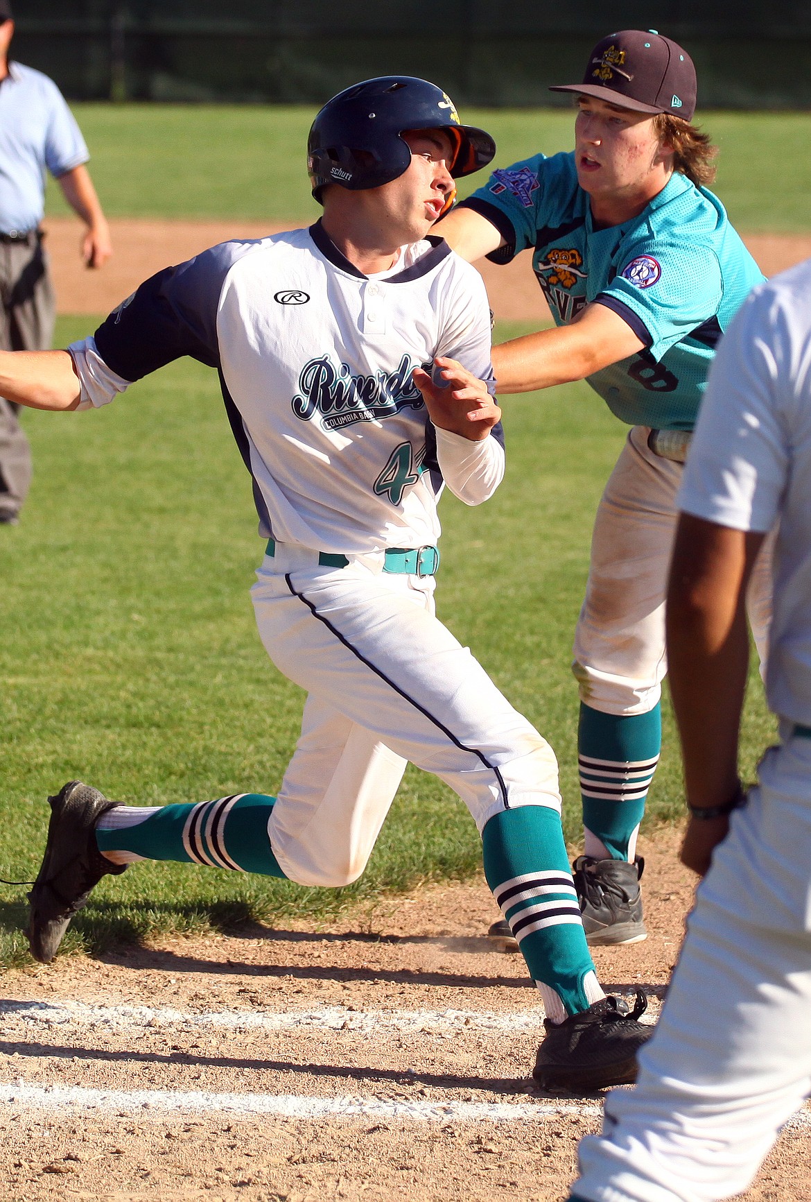 Rodney Harwood/Columbia Basin Herald - Columbia Basin River Dogs No. 1 first baseman Dax Lindgren tags out Logan McGuire (44) for the final out in the Northern Washington Babe Ruth League state championship game. River Dogs 1 defeated River Dogs 2 6-5 to win the state title.