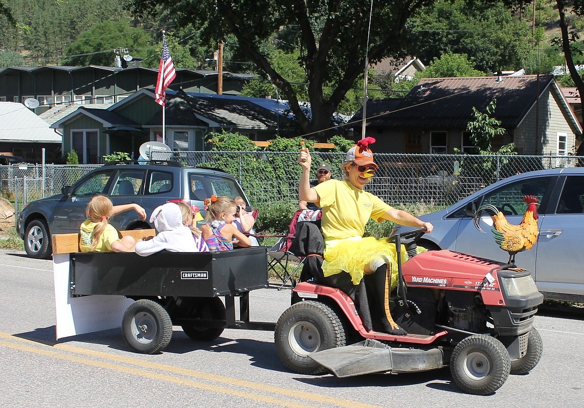 Jessie Vaillancourt plays the part of a chicken with her wagon full of chicks for the Alberton Feed Store float during the Railroad Day Parade.