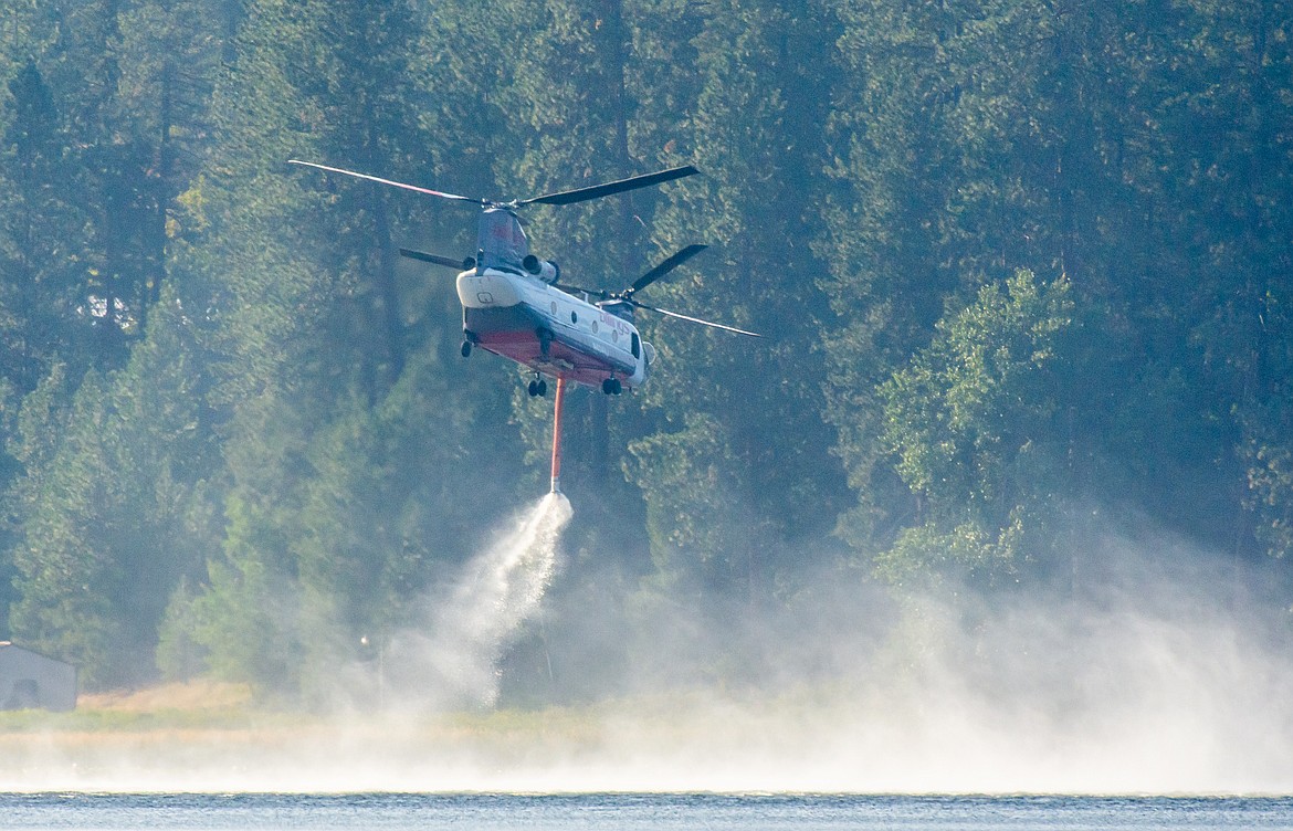 A CH46 Chinook helicopter dips its snorkel into the waters of Hauser Lake. (CHRIS CHAFFEE/Courtesy photo)