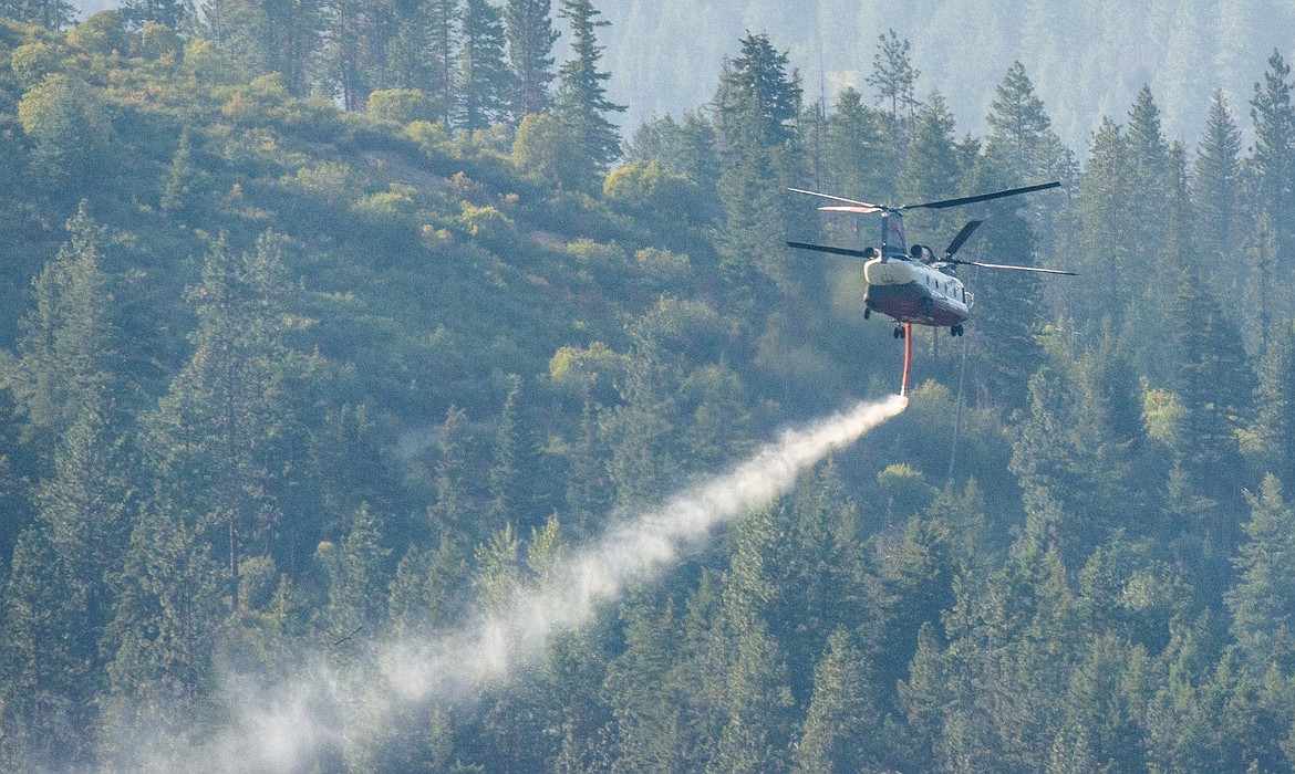 A helicopter loaded with water form Hauser Lake heads north to a wildfire. (CHRIS CHAFFEE/Courtesy photo)