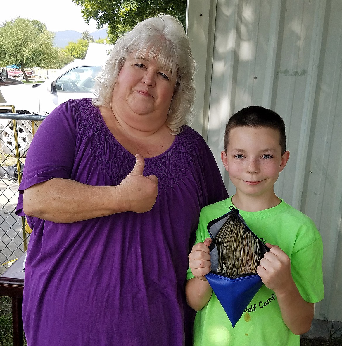 Karen Stickney gives her grand-nephew Hunter Rooney a thumbs-up for raising $1,386.14 to benefit cancer victims and their families. (Courtesy photo)