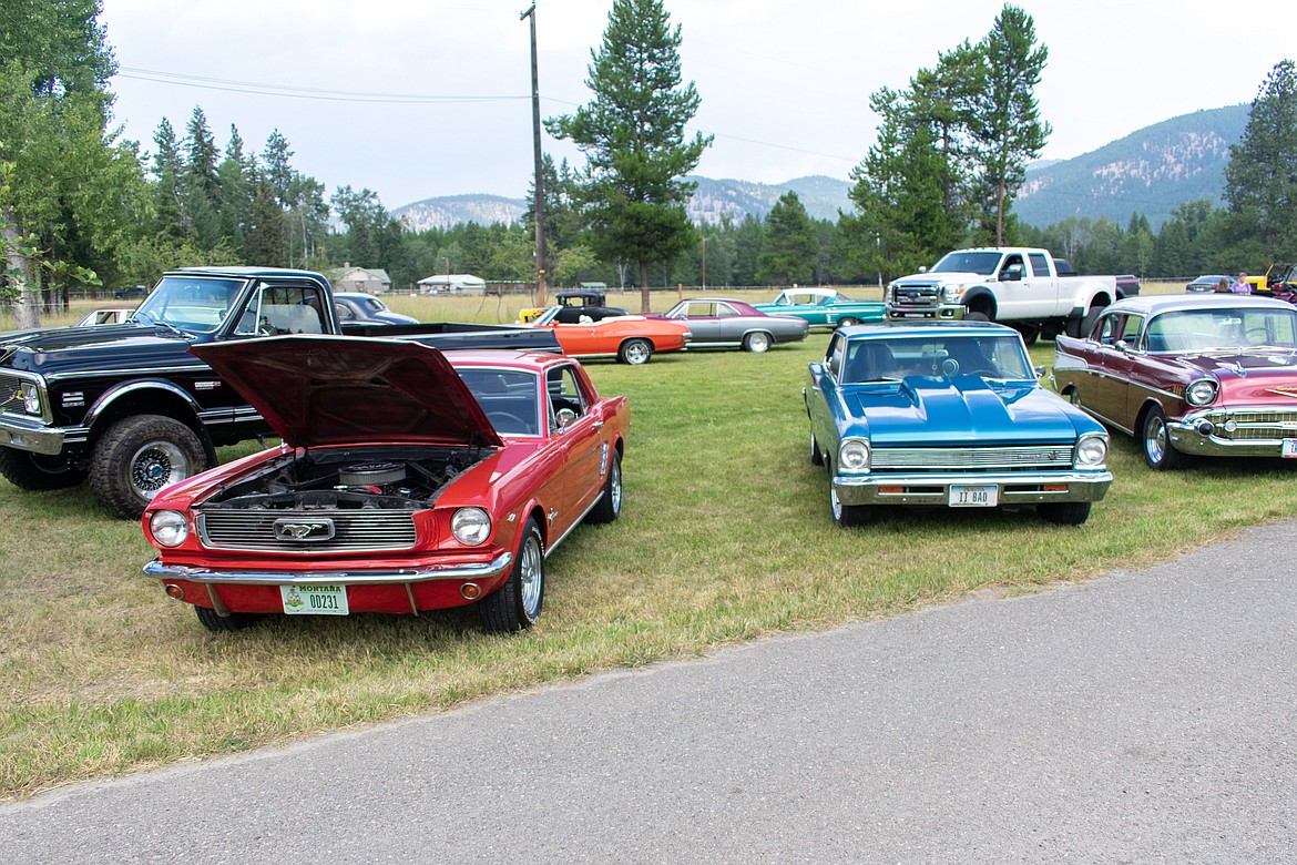 Classic, new and favorite cars fill the lawn in front of RMV Auto south of Libby for the third annual RMV Auto Car Show on Saturday. (Ben Kibbey/The Western News)