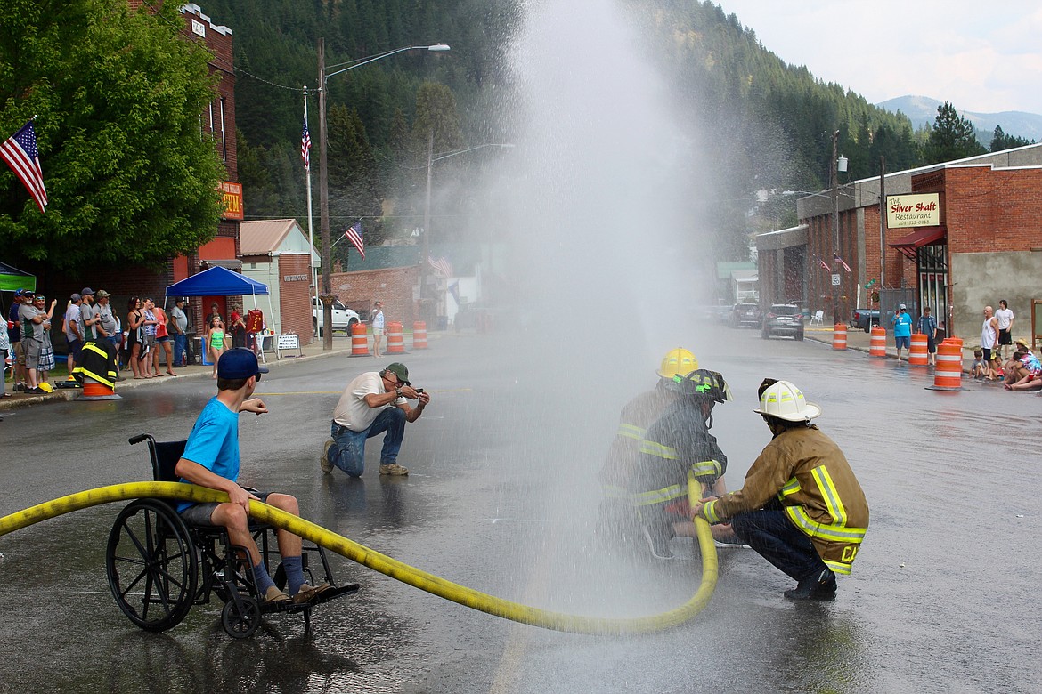 Right on target! Teams in the tug of war event had to deal with getting hit with water while aiming their hose.