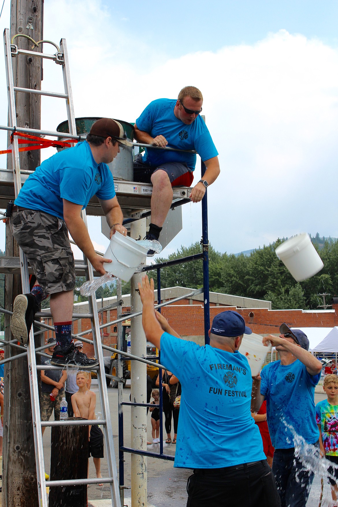 The Silver Valley Fire and Rescue team hand each other buckets of water during the bucket brigade challenge.