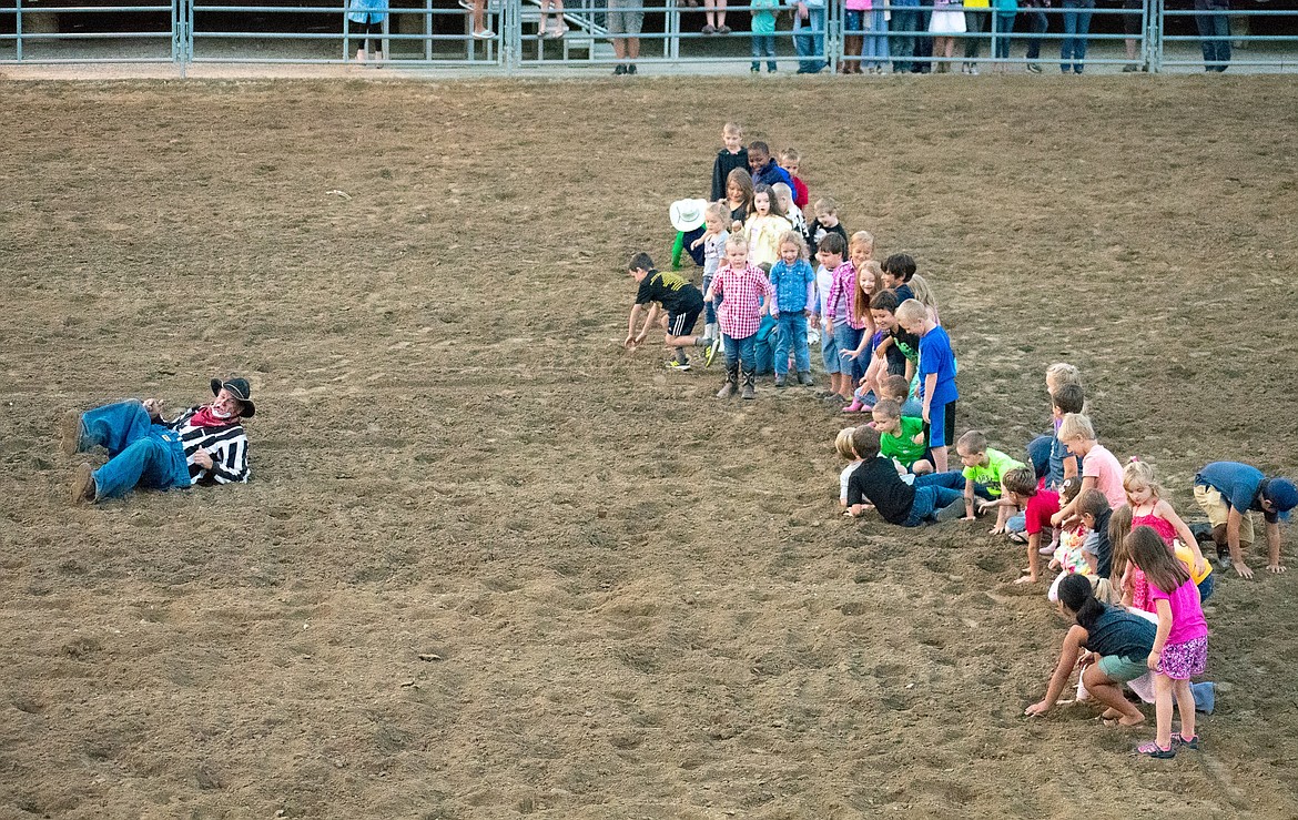 Timber Tuckness leads the 4-to-7-year-olds in a roll in the dirt before the Kids Calf Scramble, during the 2018 Kootenai River Stampede Saturday (Ben Kibbey/The Western News)