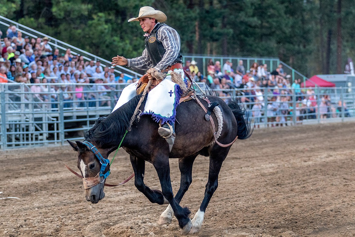 LeRoy Eash of Fortine competes in saddle bronc riding during the Kootenai River Stampede PRCA Rodeo at J. Neils Arena in Libby Friday. (John Blodgett/The Western News)