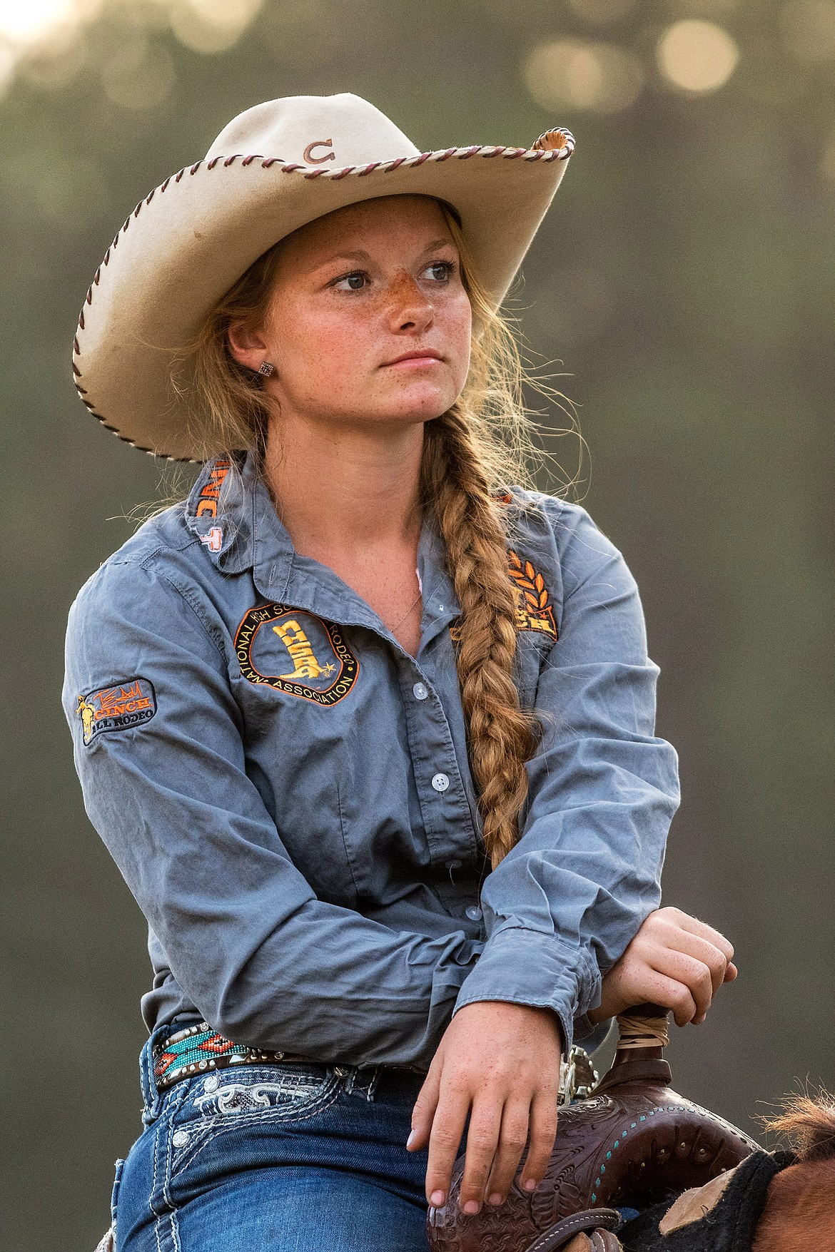 Barrel racer Heidi Schmid of Kalispell watches Kootenai River Stampede PRCA Rodeo action before competing at J. Neils Park in Libby Friday. (John Blodgett/The Western News)