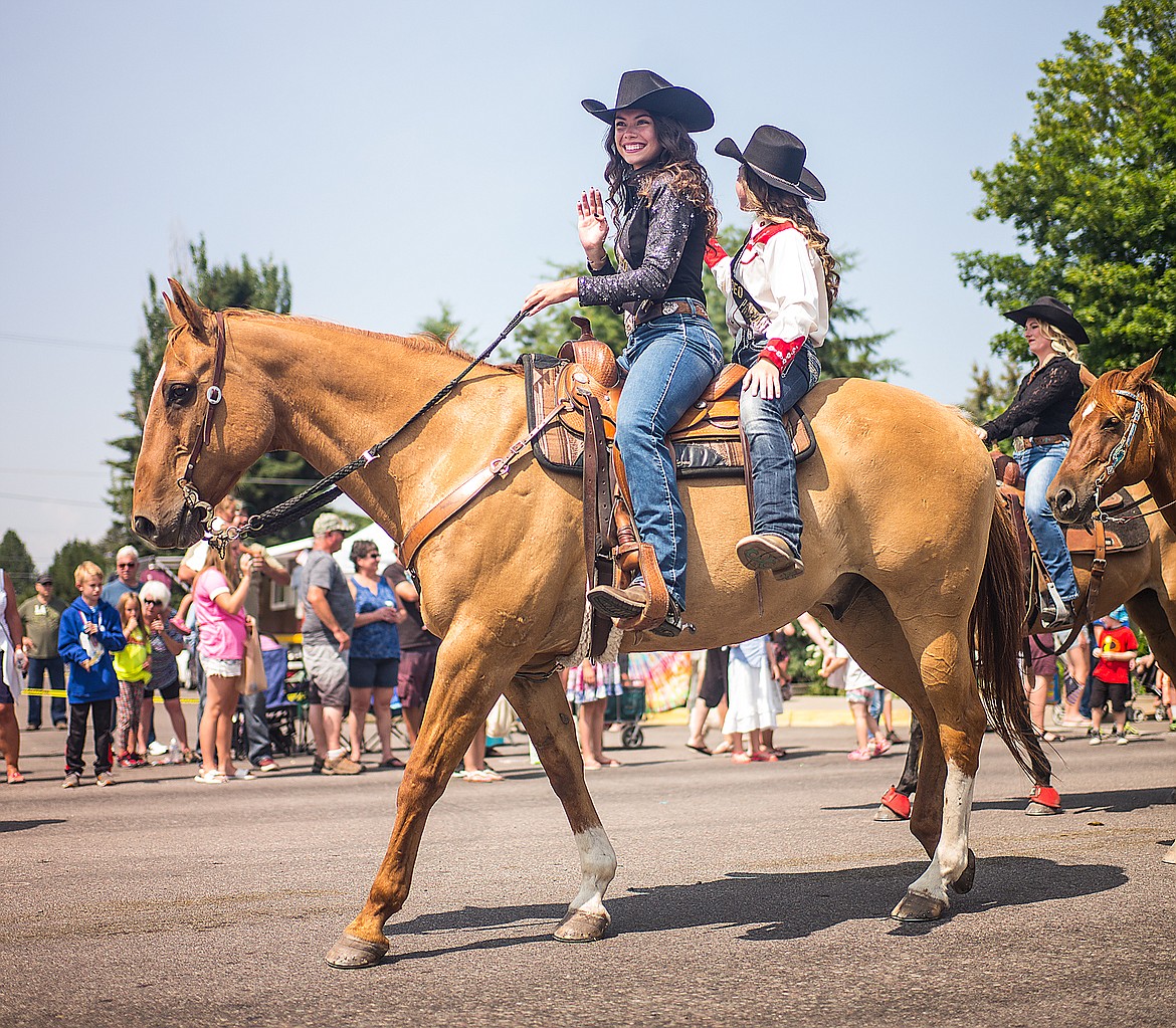 Horse riders wave to the crowd.