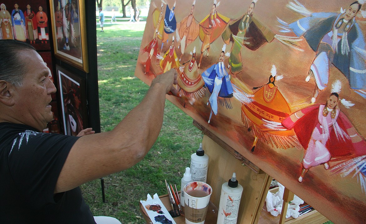 Daniel Ramirez, from Rio Rancho, N.M., works on a painting on Saturday at Coeur d&#146;Alene City Park. (BRIAN WALKER/Press)