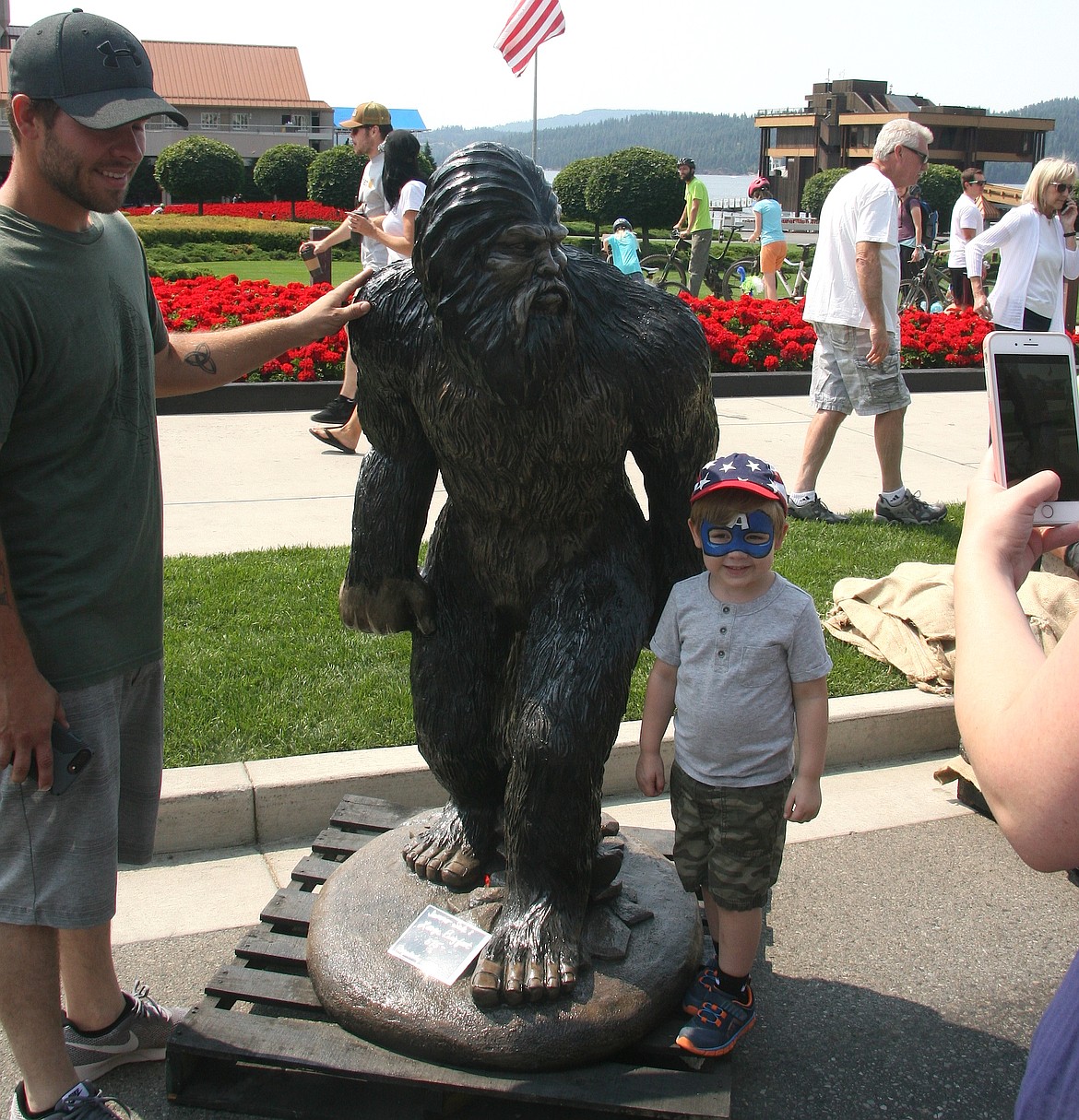 Jonah Sanchez, 3, Coeur d&#146;Alene, took his chances posing in front of Bigfoot, a product of Concrete Works, on Saturday at the Downtown Street Fair as his dad Chris stands by and mother Emily snaps a quick photo. (BRIAN WALKER/Press)