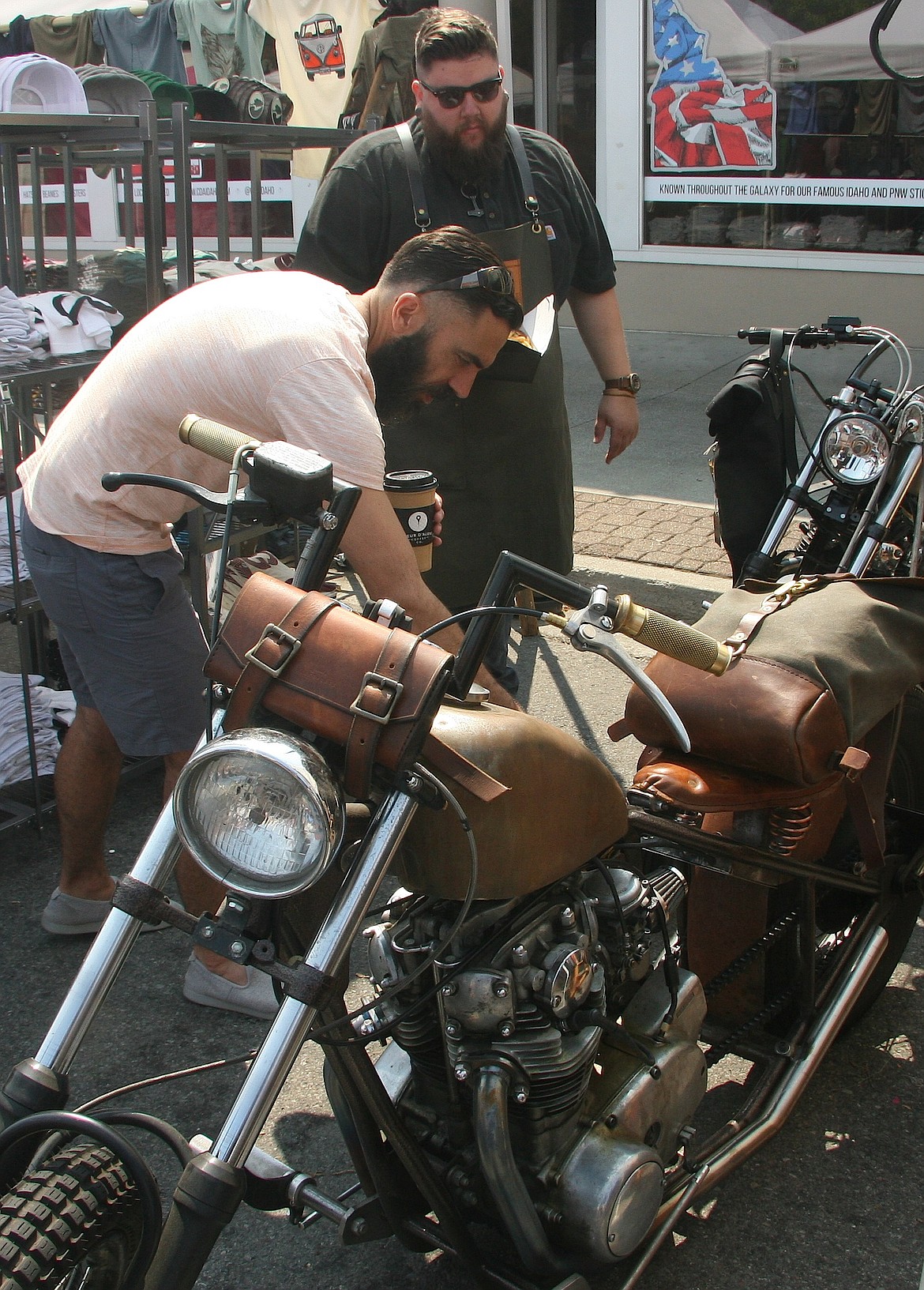 Mat Wintzer, left, Coeur d&#146;Alene, checks out the custom leather accessories on a 1979 Yamaha XS 650 on Saturday at the Downtown Street Fair on Sherman Avenue in Coeur d&#146;Alene as maker Mike Miles of Craft and Lore explains the craftsmanship.

Photos: BRIAN WALKER/Press