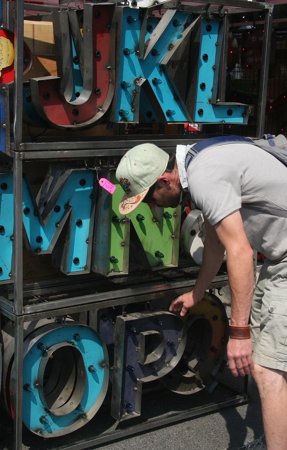 Austin Parent, Post Falls, observes lighted letters on Saturday at the Downtown Street Fair. (BRIAN WALKER/Press)