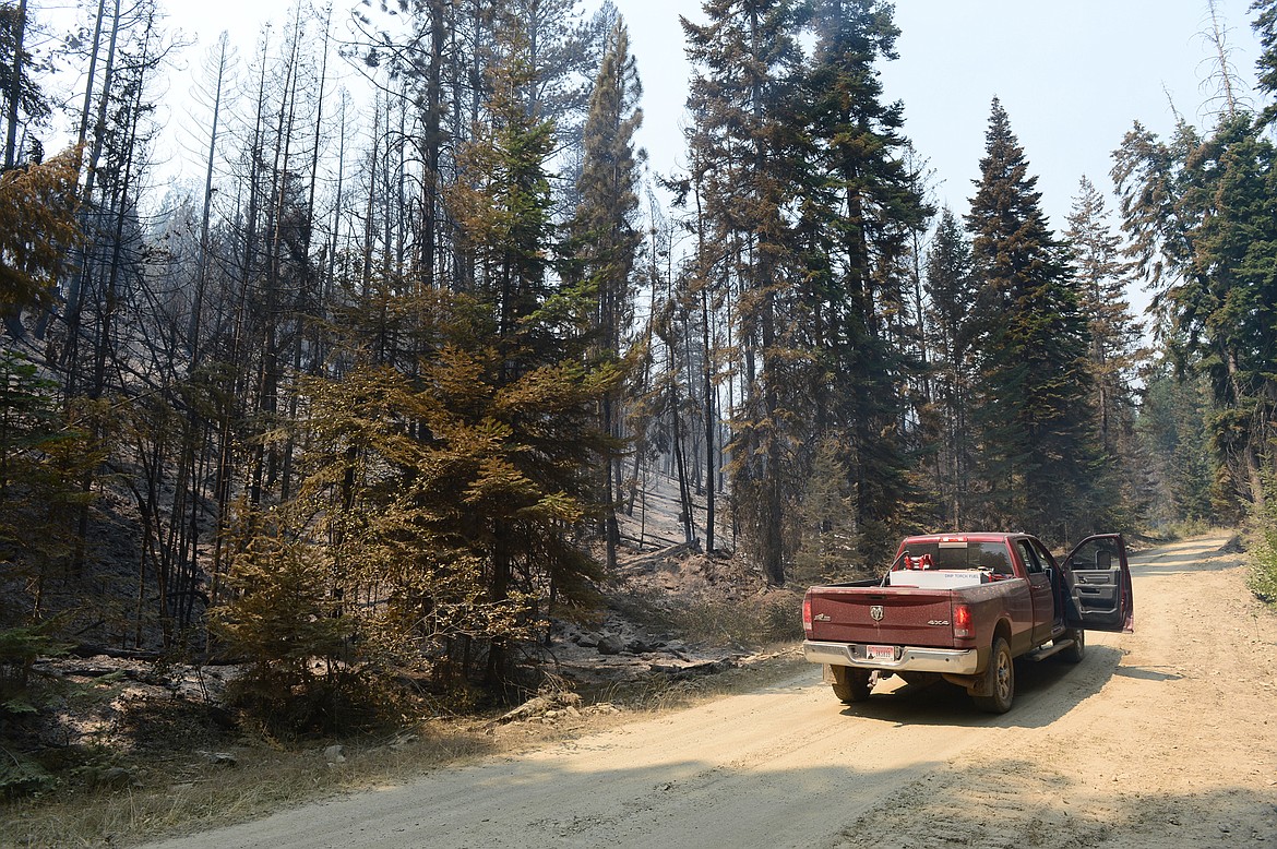 Smoke from the Garden Creek Fire lingers on a charred section of hillside near Hot Springs on Thursday. (Casey Kreider/Daily Inter Lake)