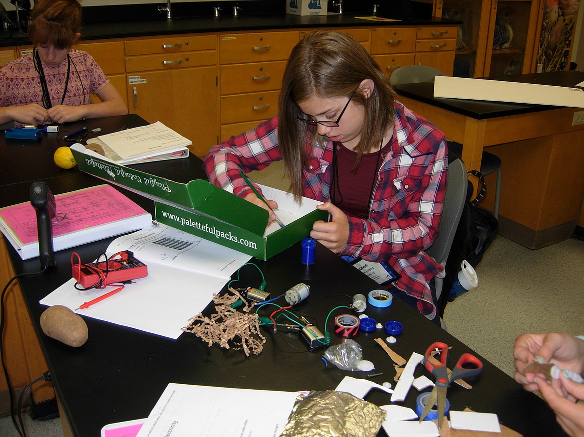 Photo by BETSY McTEAR
Lauren Hibbs, 13, of Post Falls, designs a toy that uses a direct current motor while working in the electricity class Thursday during Tech Trek, a science, technology, engineering and mathematics camp especially for girls interested in STEM studies. &#147;I think that women should be able to be engineers and scientists and all those things,&#148; Lauren said. &#147;People need to understand that women can do those things, too.&#148;