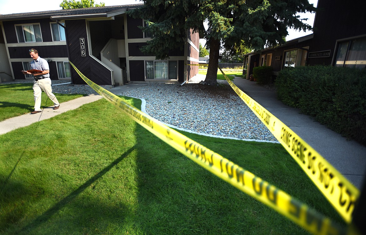 Sheriff-elect Brian Heino, serving as coroner, steps out of an apartment at 306 Two Mile Drive on Sunday morning, August 5, in Kalispell. The scene is currently under investigation by the Kalispell Police Department Major Crime Unit.(Brenda Ahearn/Daily Inter Lake)