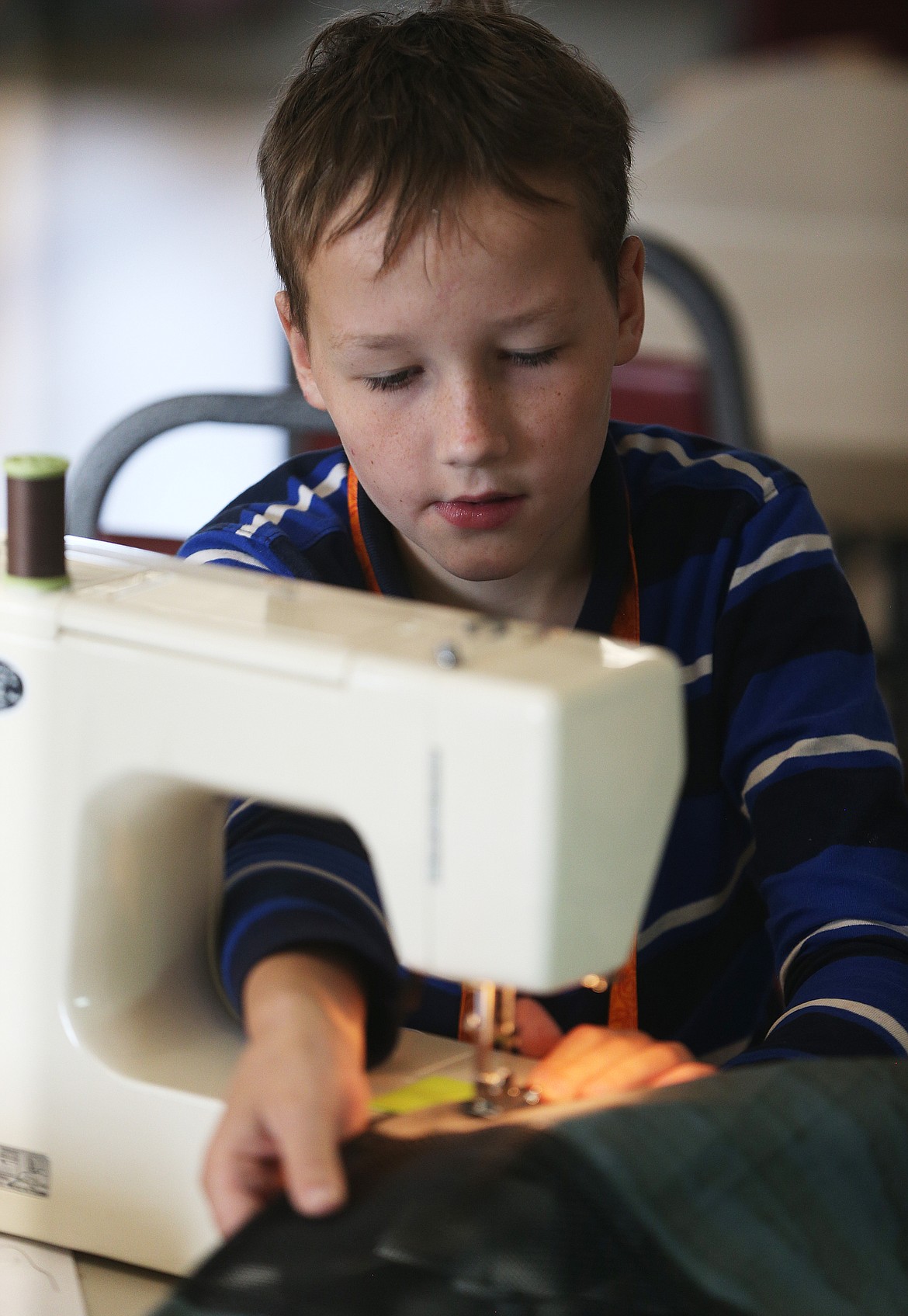 David Balija, 10, sews a backpack during the annual youth sewing and quilting camp Tuesday afternoon at the Coeur d'Alene Shrine Club Event Center in Hayden.   (LOREN BENOIT/Press)