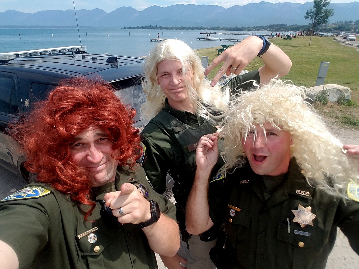 From left, Trooper TJ Templeton of Missoula, Trooper Noah Pesola and Trooper Laramie Stefani of the Kalispell District pose for a selfie in the wigs they wore the day of the Montana Highway Patrol Lip Sync Challenge video in Polson. (Photo courtesy of Trooper Laramie Stefani)