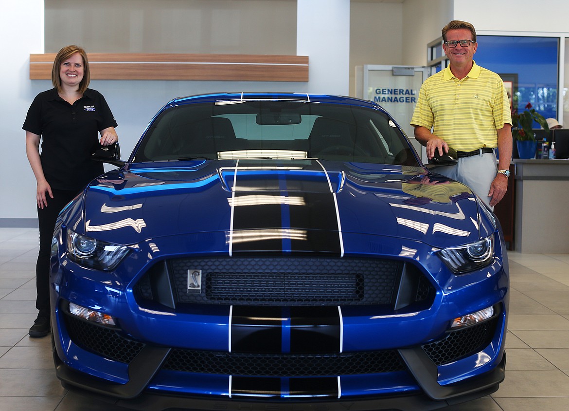 Mike White and his daughter, Chelsea, pose for a portrait in the newly remodeled showroom at Mike White Ford of Coeur d&#146;Alene, 315 W. Clayton Ave. That&#146;s a 2018 Shelby GT 350 between them.