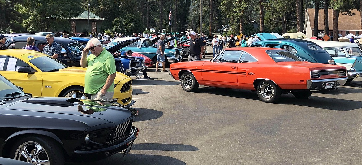 The crowd moves throughout the car show at Pinehurst Days. Some of the cars were cool enough people had to lift their shades just to take it all in.