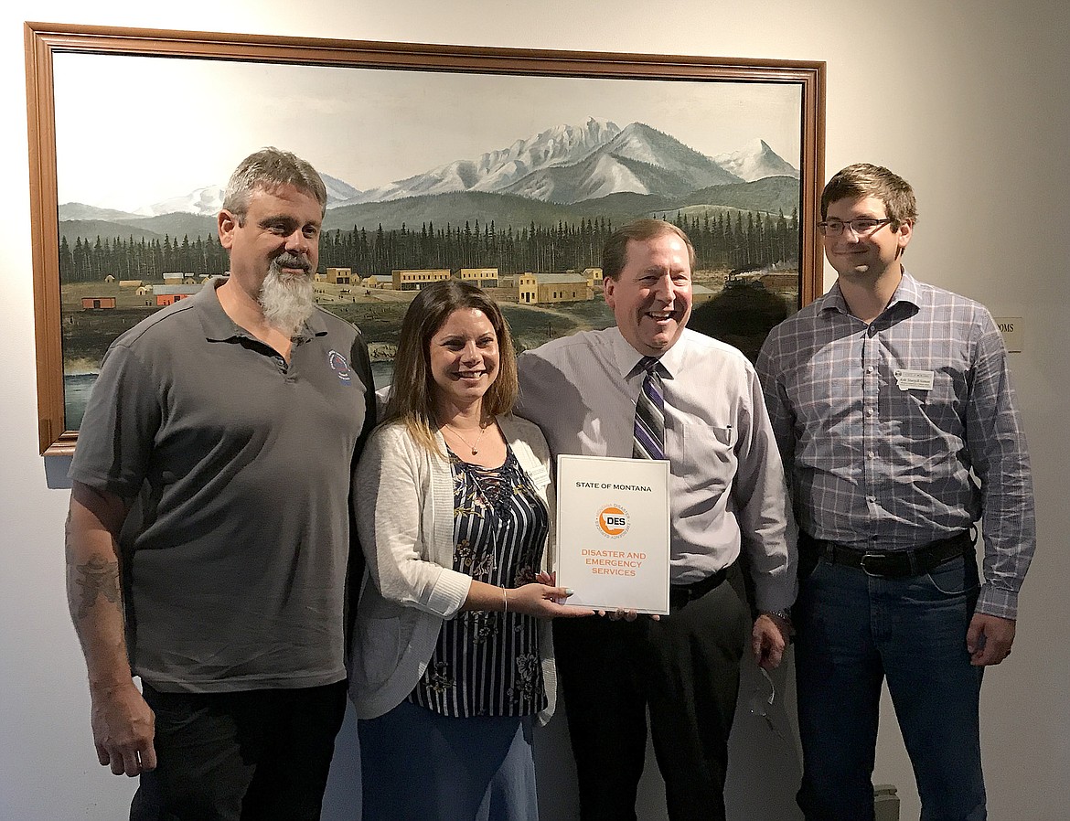 Lincoln County recently was awarded a $25,000 grant from the Federal Emergency Management Agency to cover three-quarters of the cost of developing a pre-disaster mitigation plan. Pictured following the announcement of the award at the Aug. 1 meeting of the Lincoln County Commission are, from left: Brent Teske, director of the county’s Emergency Management Agency; Nadene Wadsworth of Montana Disaster and Emergency Services; County Administrator Darren Coldwell; and Kyle Sturgill-Simon of Montana Disaster and Emergency Services. (John Blodgett/The Western News)
