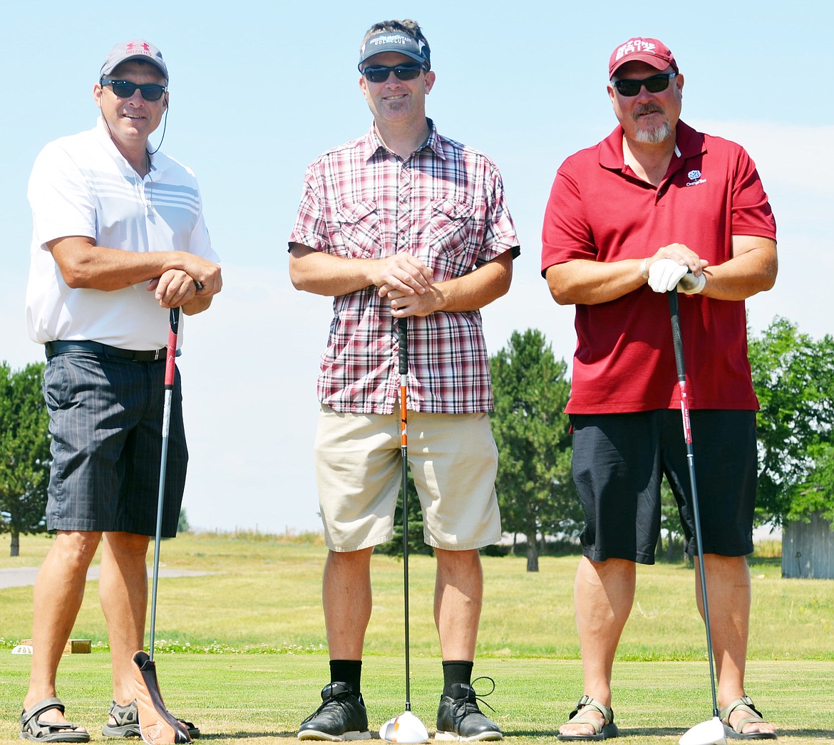 CONTESTANTS Marvin Courville (left) and Stacy Courville (right) pose with new owner of the Mission Valley Golf Course Shawn Wilson (middle) Friday afternoon at Mission Mountain Golf Course in Ronan. The golf course hosted a highly successful Pioneer Days Golf Scramble. (Jason Blasco/Lake County Leader)