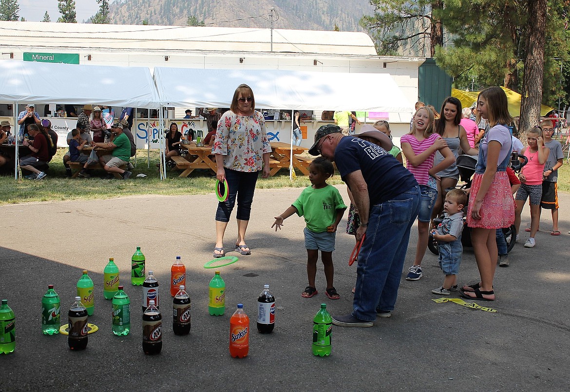 KIDS LINED up for a chance to win a giant bottle of soda at the ring toss game during this year&#146;s Mineral County Fair in Superior.