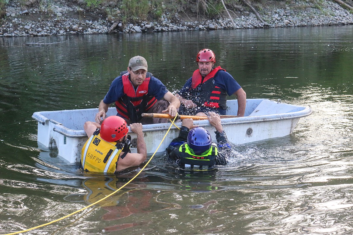 Photo by MANDI BATEMAN
The mock victims played the part of victims trying to capsize the boat in mock panic.