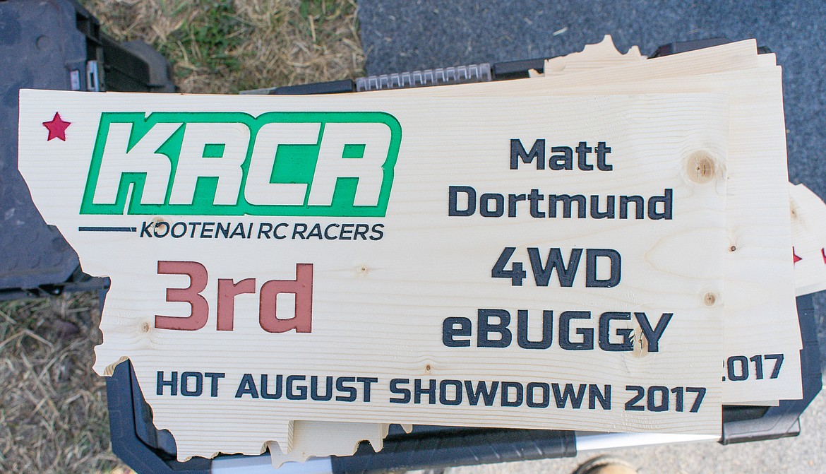 Trackside, a stack of trophies from last year await transport with John and McCoy Starkey back to some Washington racers who didn&#146;t make it this year to pick them up, during final races of the Kootenai RC Racers&#146; Hot August Showdown on Sunday. The trophies are designed and created by Sam Scheer. (Ben Kibbey/The Western News)