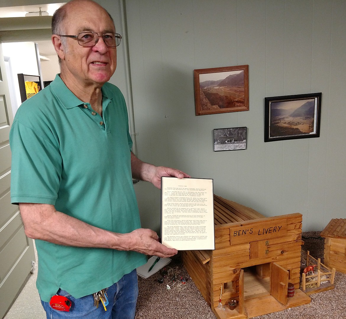 Paradise Elementary School Preservation Committee member John Thorson holds a frame depicting the small town miniatures made by Harvey Gould now on display at the Paradise Center. (Joe Sova/Clark Fork Valley Press)