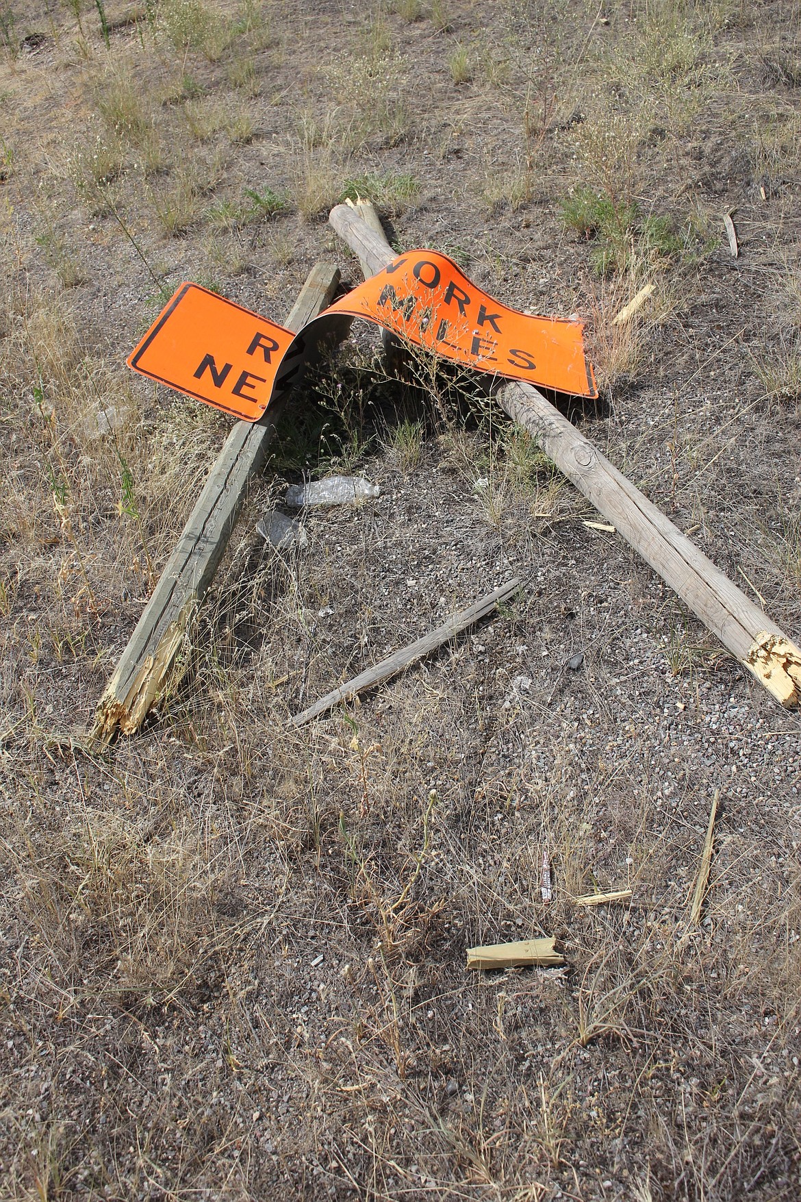 A &#147;Road Work Ahead&#148; sign was destroyed as a snapped phone cable tangled traffic on Interstate 90 near Superior on July 24. (Kathleen Woodford/Mineral Independent)