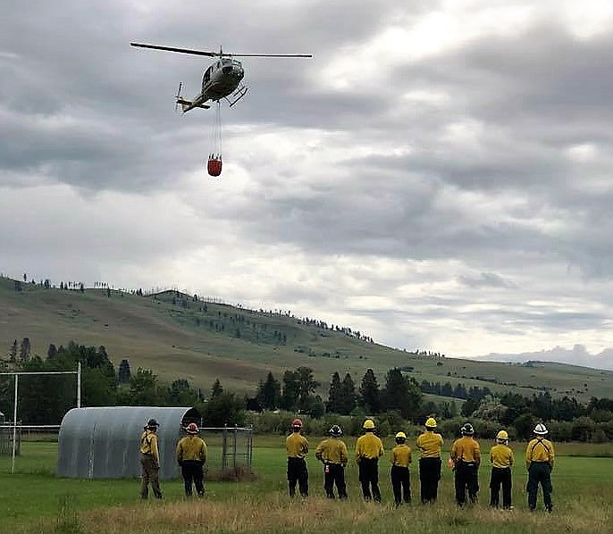 A Department of Natural Resources and Conservation helicopter training session takes place with new Frenchtown Rural Fire Department District members on July 2. They are trained on how to call in a bucket drop. (Photo courtesy of Frenchtown Rural Fire Department)