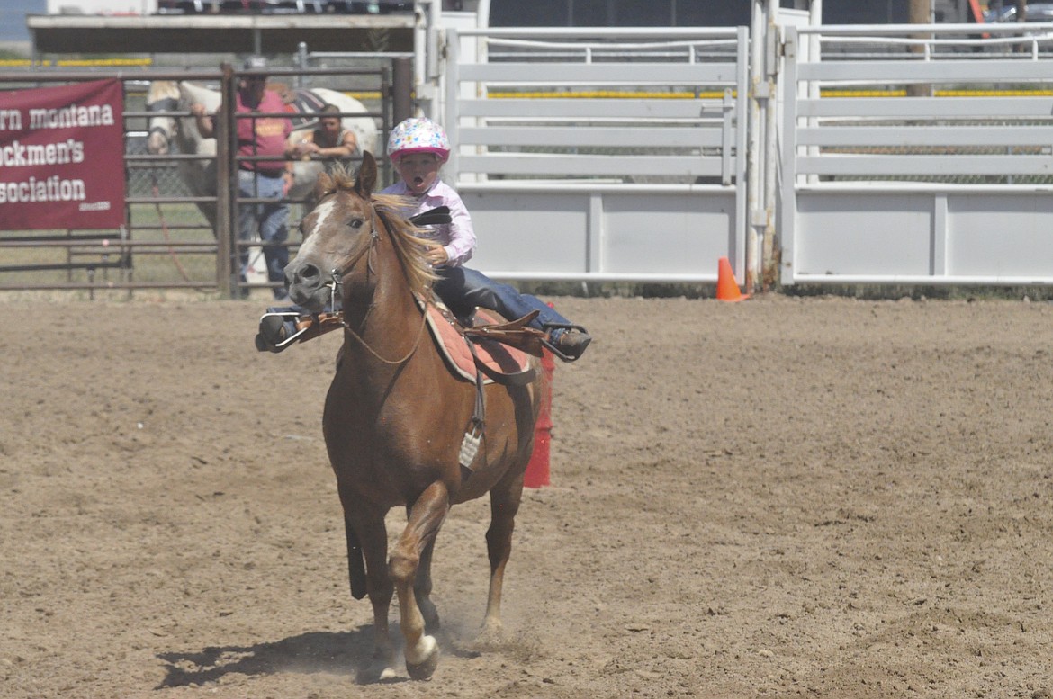 KESTIN MARMON and her horse Dixon participate in the Barrel Race Sunday at the closing of the Lake County 4-H Fair in Ronan. Marmon and Dixon finished in seventh place with a time of 33.445. (Ashley Fox/Lake County Leader)