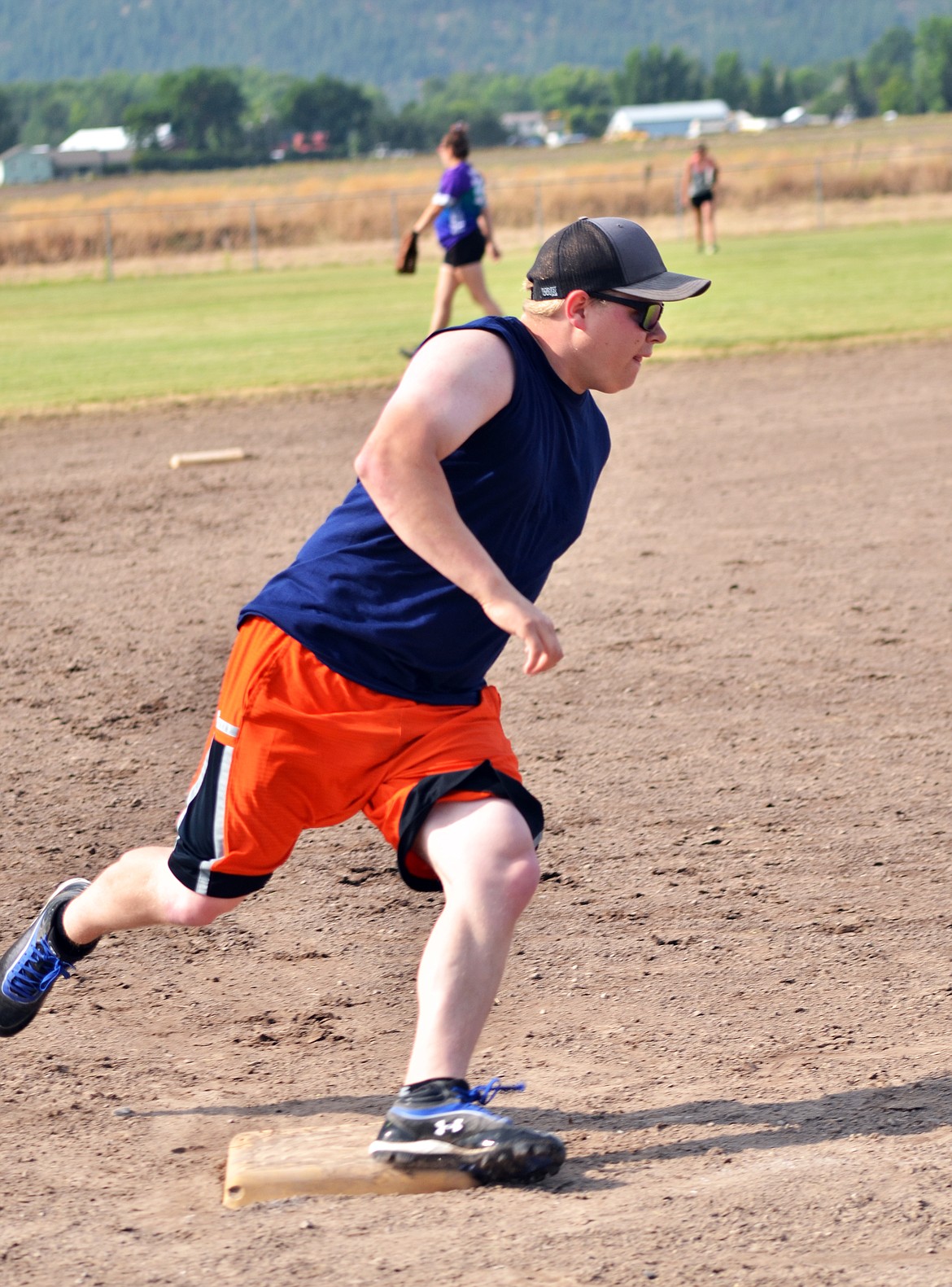 Carson Lilja rounded third bsae headed for home plate to secure a run for the Printery team during the softball tournament. (Erin Jusseaume/ Clark Fork Valley Press)