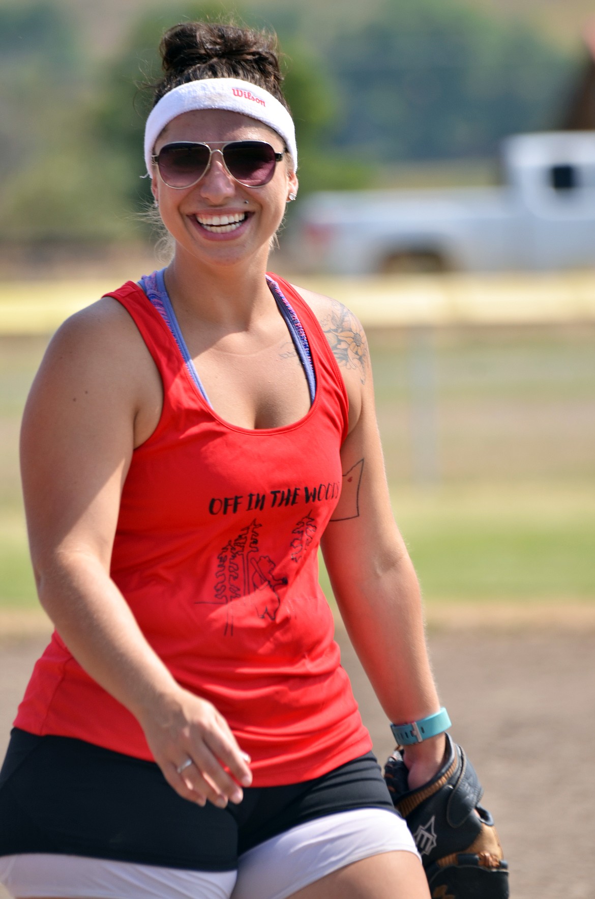 Softball enthusiast Keaton Jones was all smiles as she hedaed back to right field. (Erin Jusseaume/ Clark Fork Valley Press)