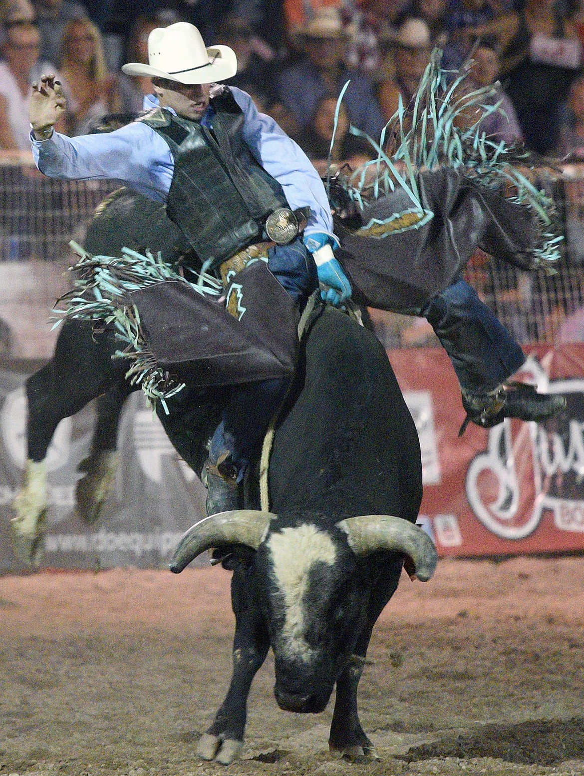 J.T. Moore, of Alvin, TX, holds on to his bull Rapid Fire during the bull riding event at the Northwest Montana Fair PRCA Rodeo on Friday evening at the Flathead County Fairgrounds. (Casey Kreider/Daily Inter Lake)